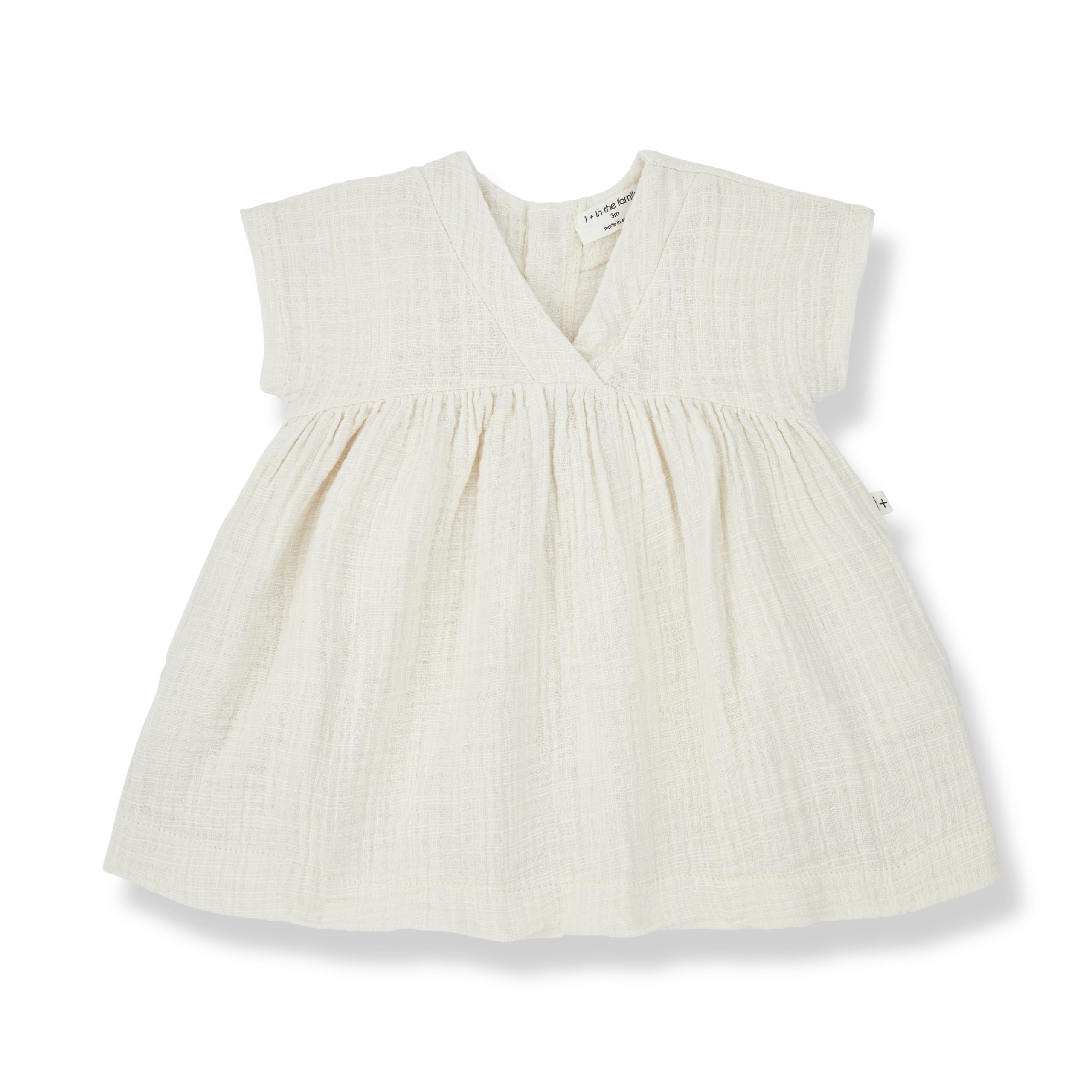 Robe bébé fille en coton ivoire avec encolure en V et manches courtes – Modèle Alberta de la marque 1+ in the Family.
