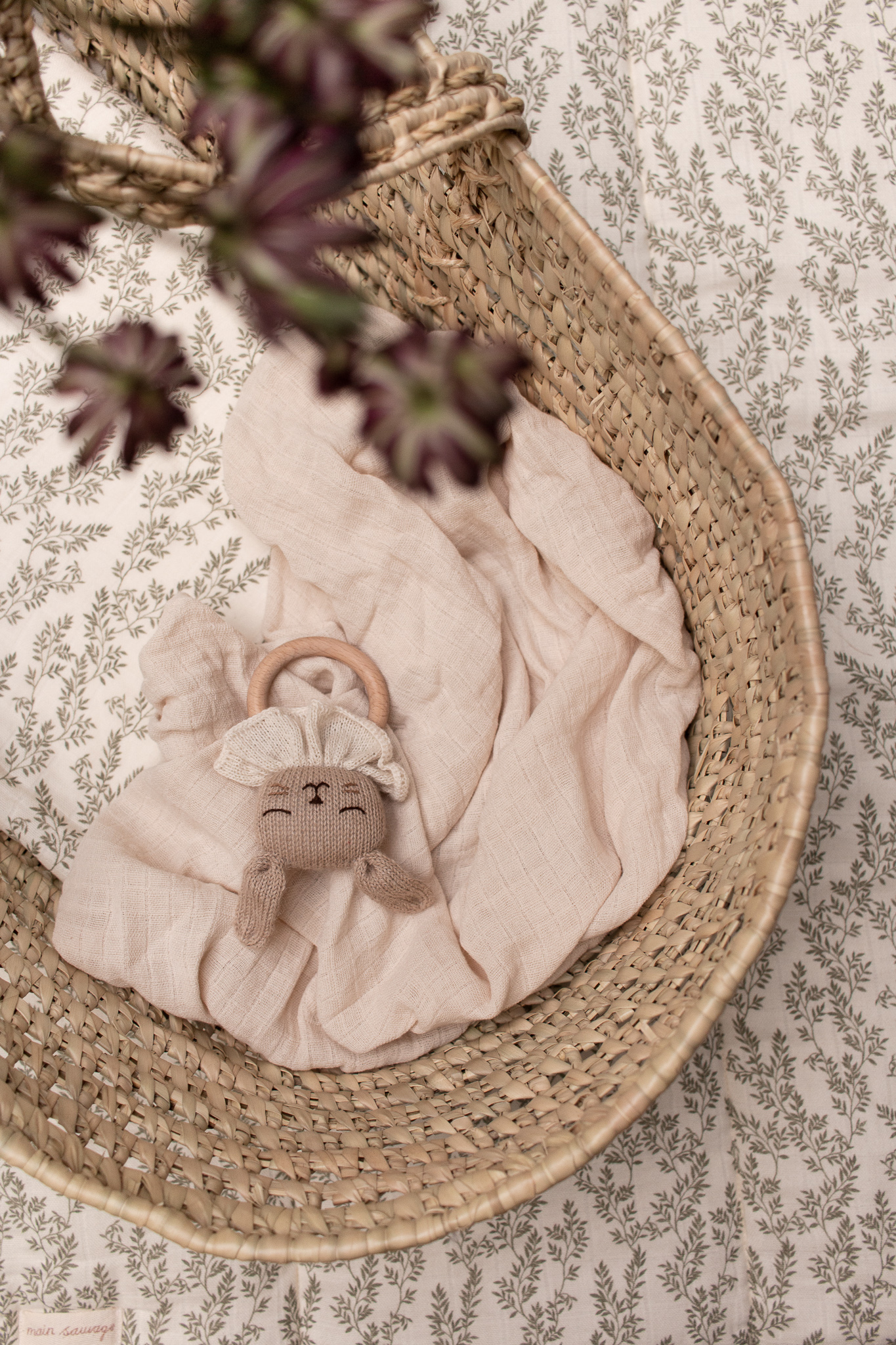 Anneau de dentition Lapin sable Main Sauvage dans un panier avec lange rose sur un drap – ambiance cocooning