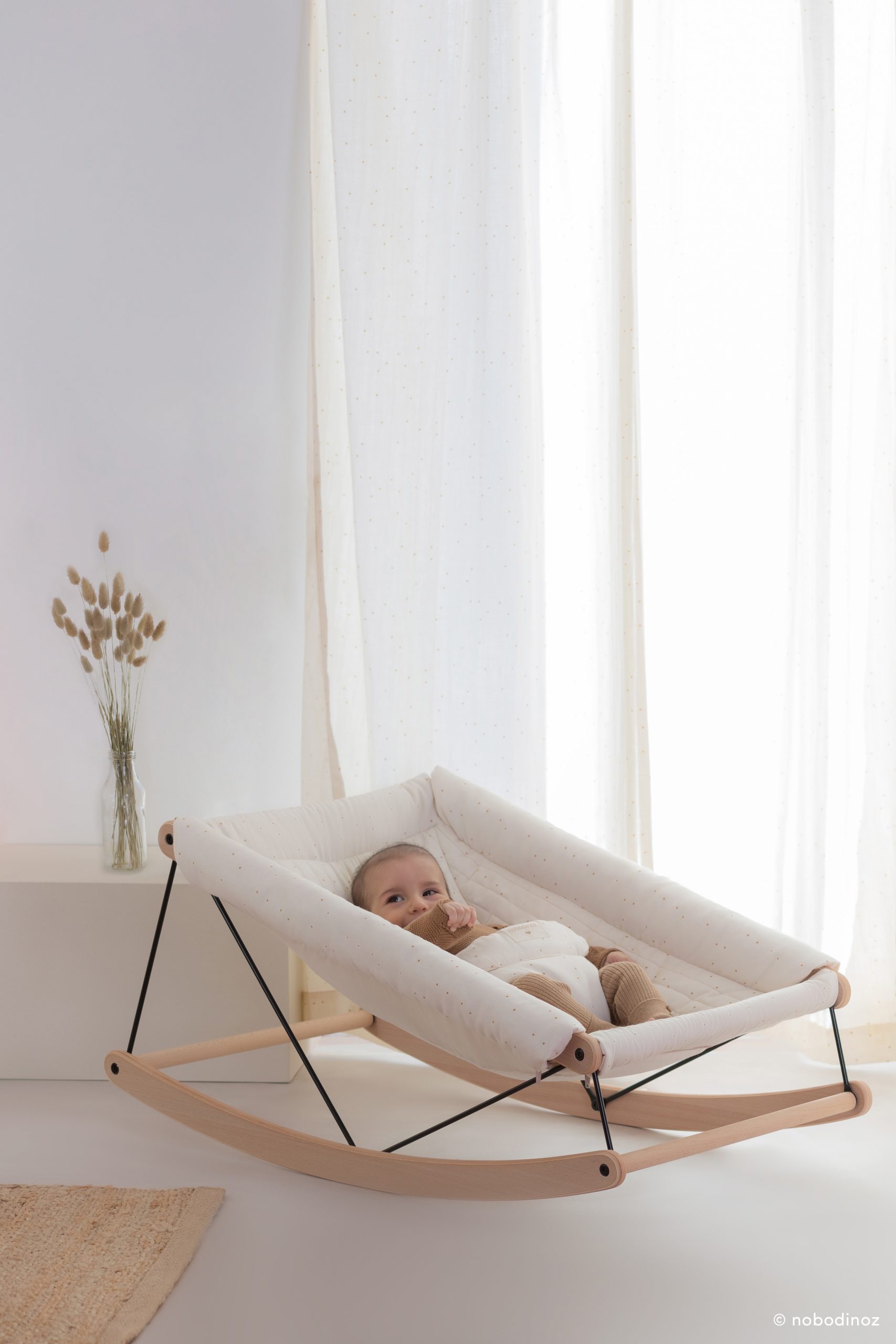 Bébé installé dans le transat bébé Nobodinoz Growing Green Honey Sweet Dots.