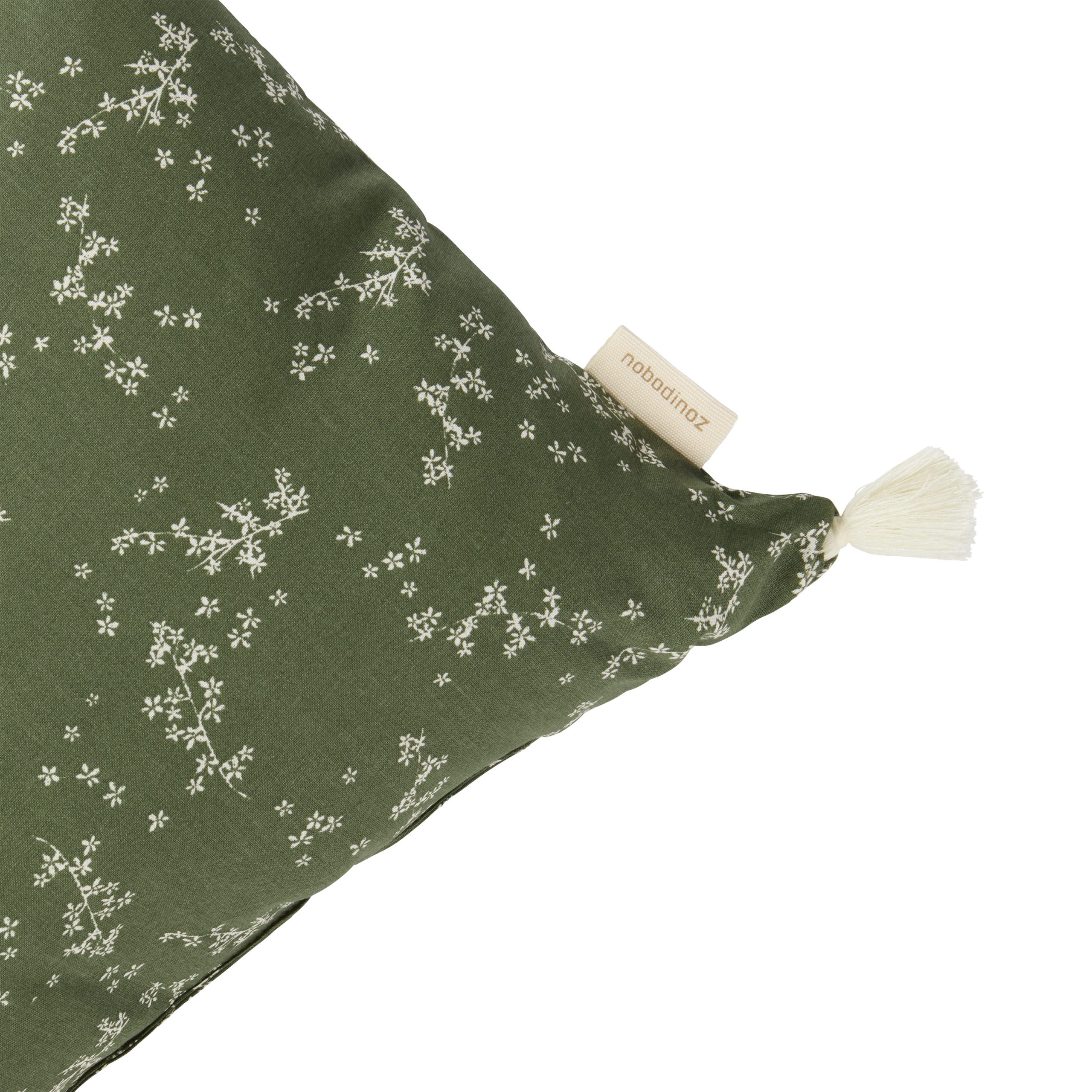 Détail du Coussin bébé vert nobodinoz rectangulaire Stories Green Jasmine avec pompon et étiquette