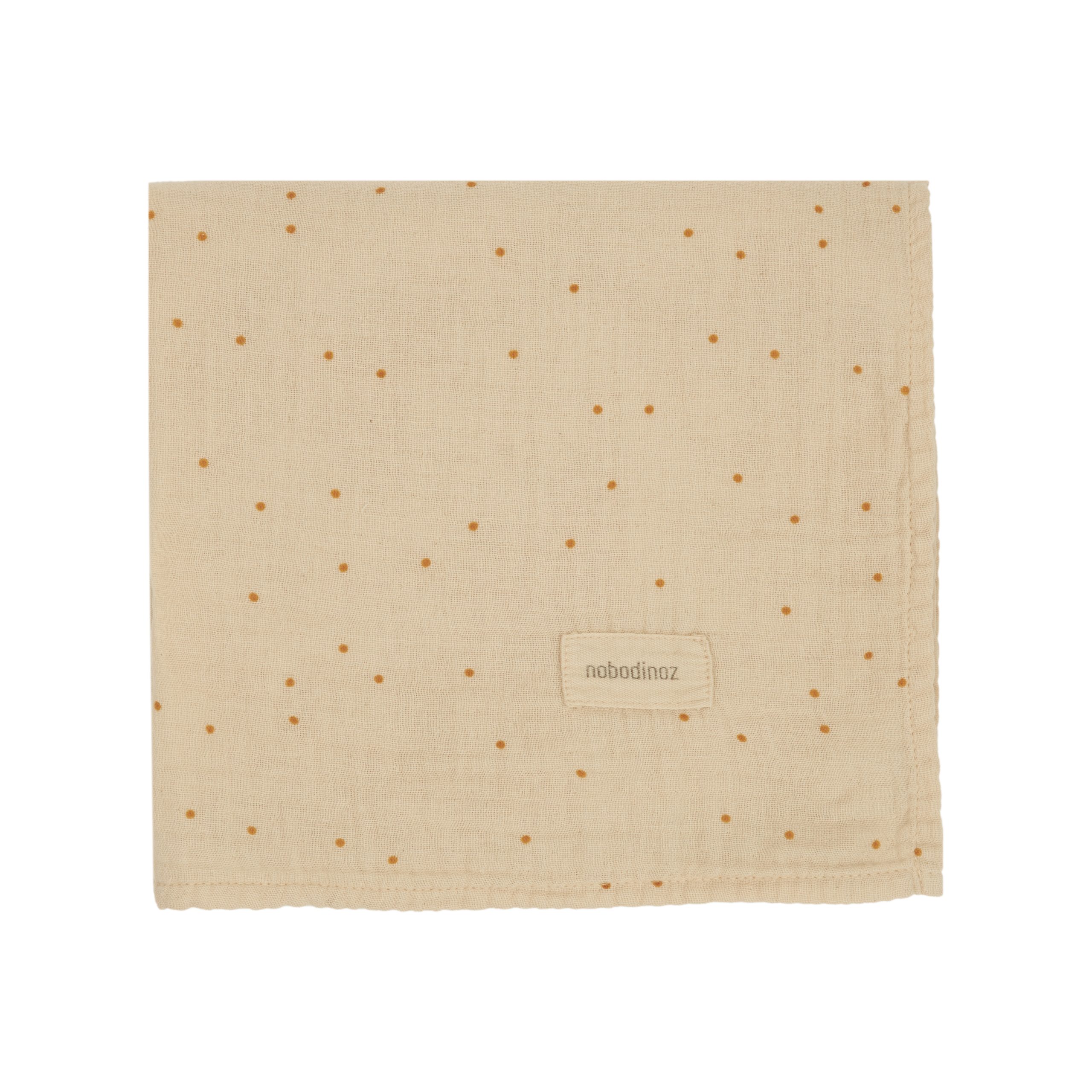 Lange bébé Wabi-Sabi Ginger Nobodinoz plié – coton bio à petits pois dorés.