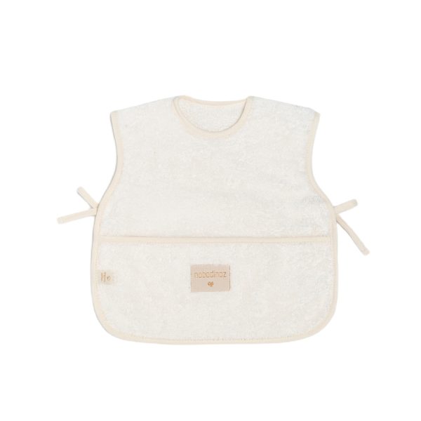 Bavoir tablier bébé Nobodinoz Natural 6-18 mois avec poche récupératrice et fermetures latérales matière éponge de coton bio