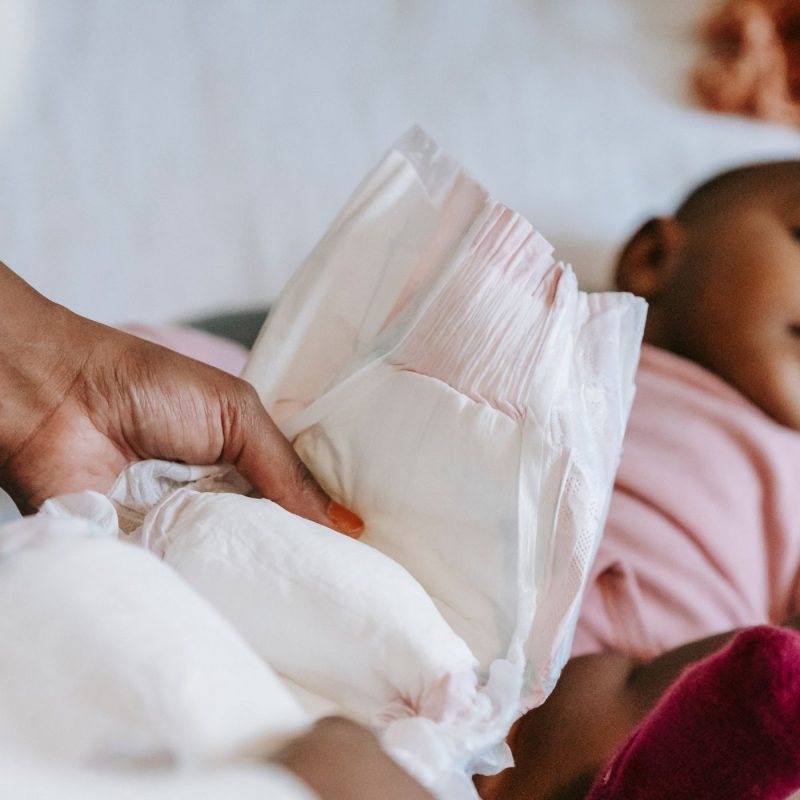 Parent tenant une couche avant de changer son bébé – nombre de couches par jour
