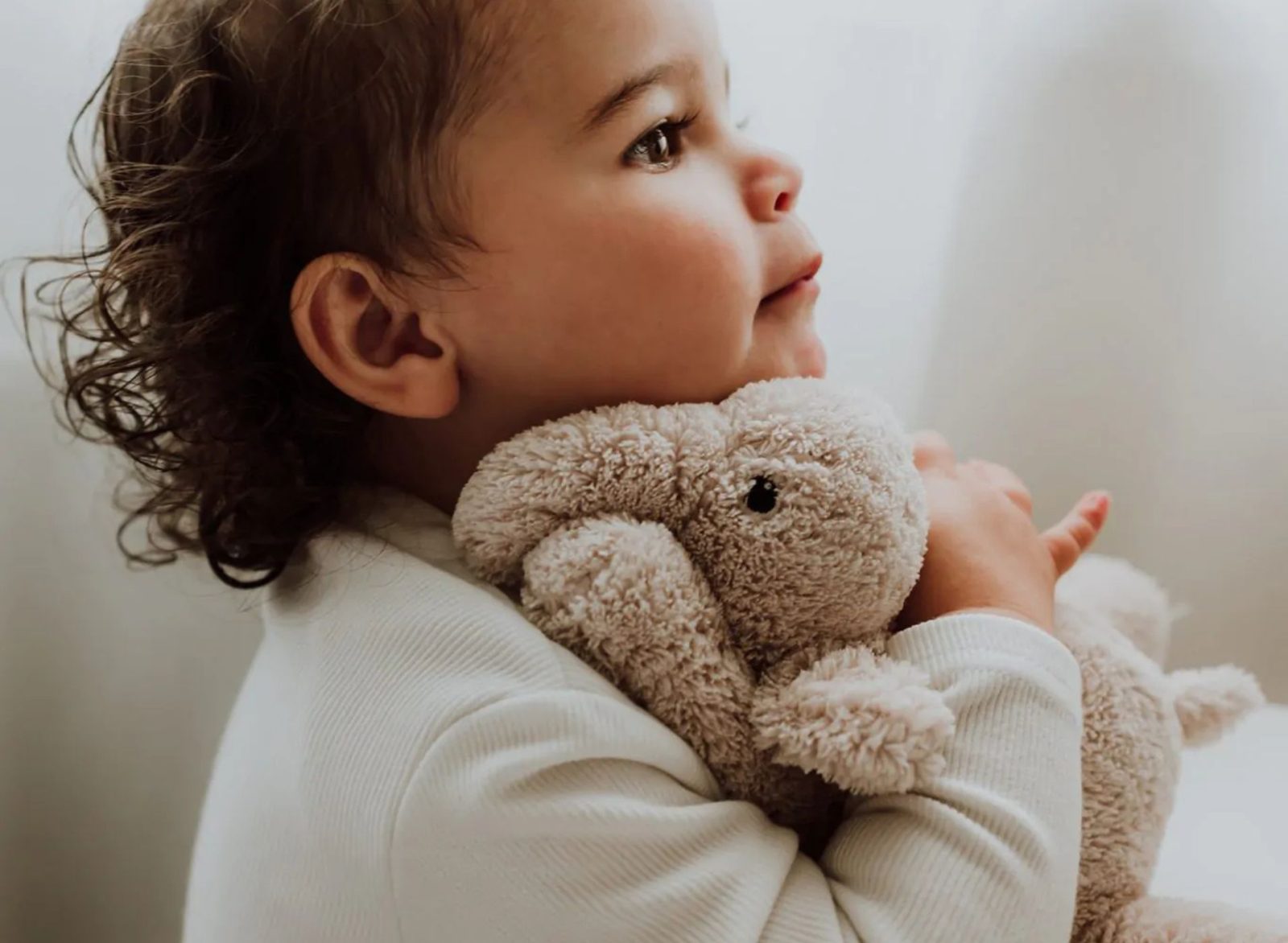 Bébé tenant une peluche bruit blanc Flow Amsterdam de couleur beige